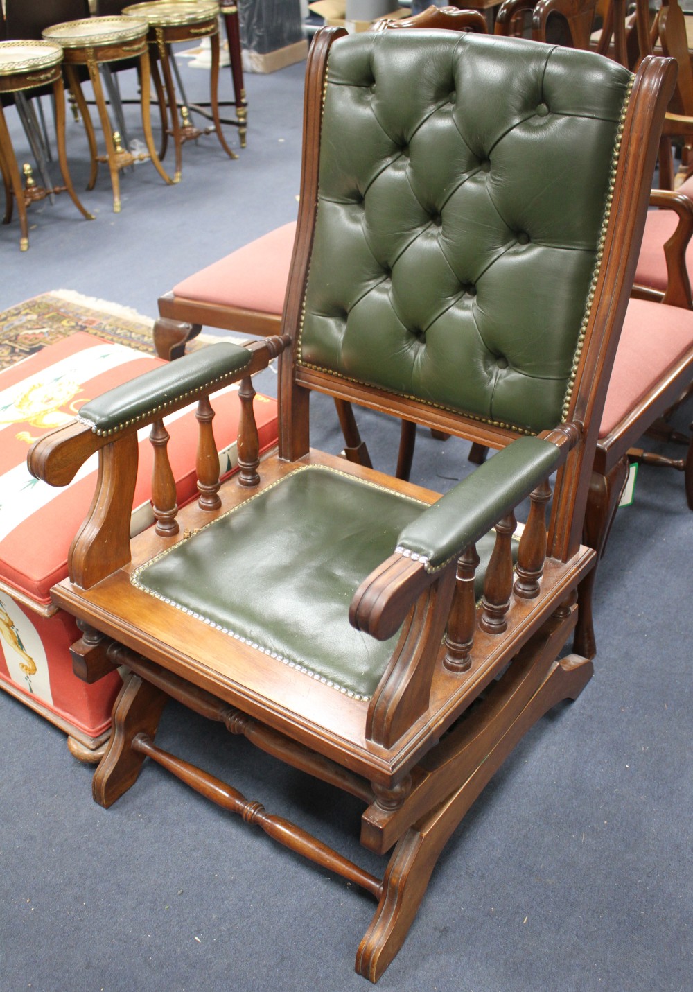 A Victorian style rocking chair with buttoned green leather upholstery, W.59cm D.74cm H.105cm